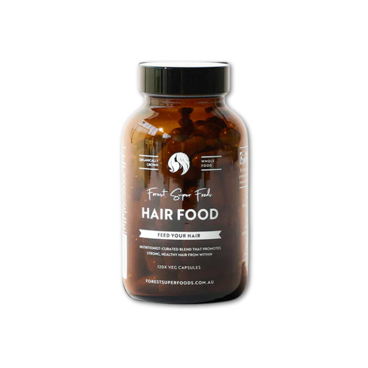 Amber glass bottle with black lid containing Forest Super Foods Hair Food nutrient blend capsules on black background